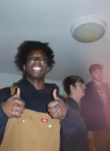 Ekow smiling holding two thumbs up