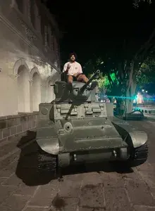 DJ on top of a military tank