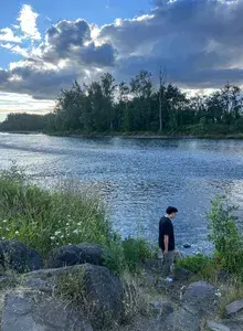 Carlos walking along a large river