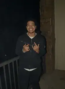 Boston smiling holding up his hands