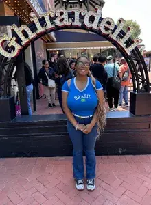 Amari smiling in front of a Ghirardelli arched sign
