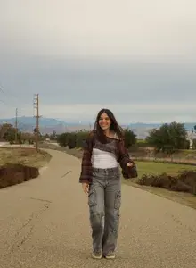 Sarah standing on a road smiling