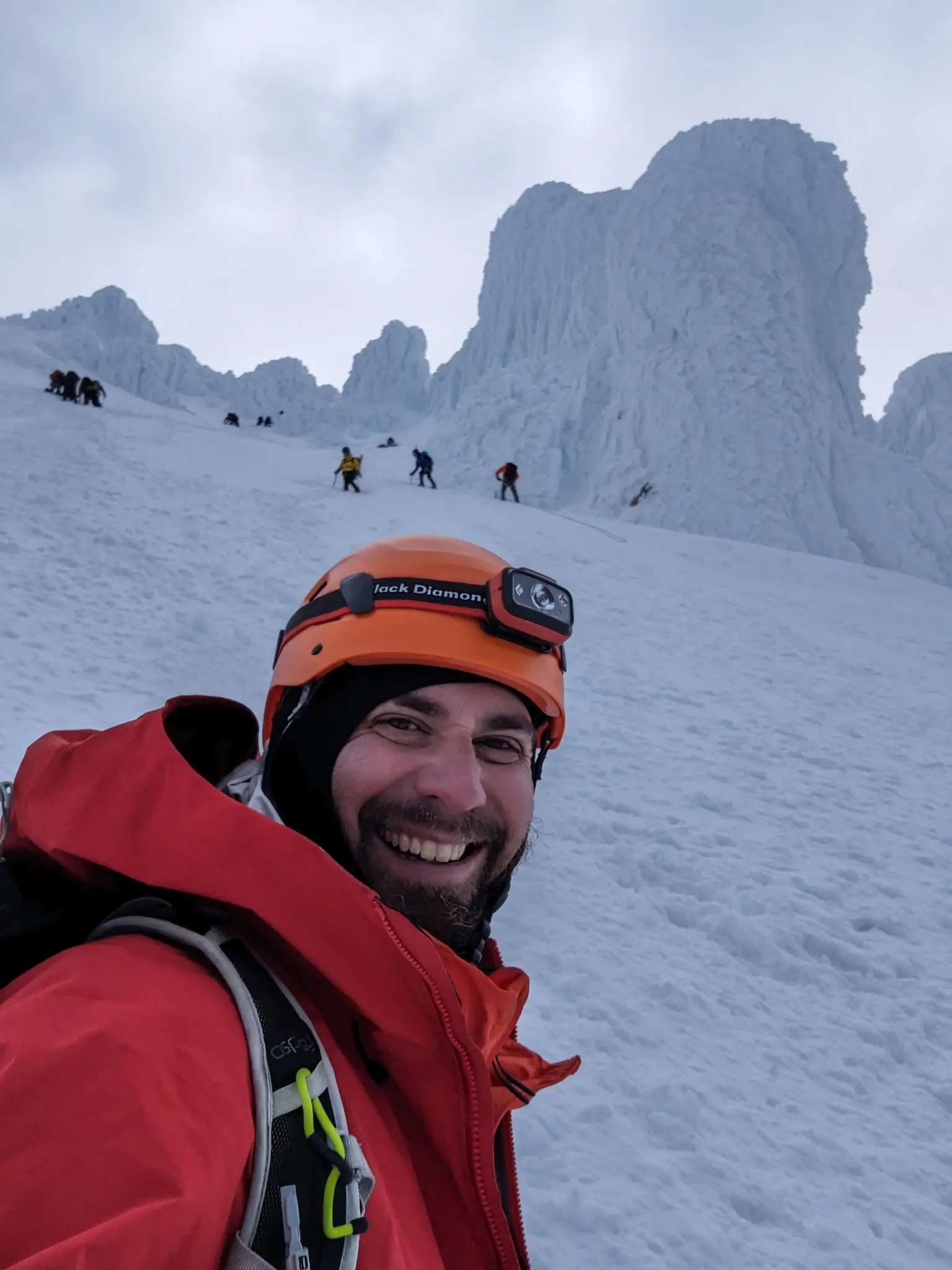 Adam snow hiking with a helmet and headlamp on